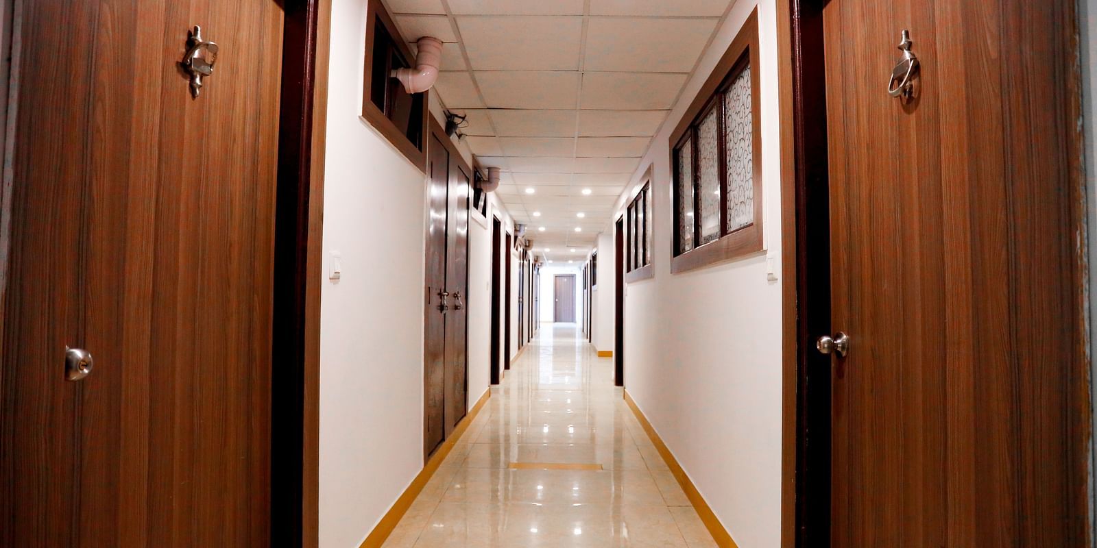 Image of a hallway with doors on the side at Amara Hill Queen, Mussoorie.