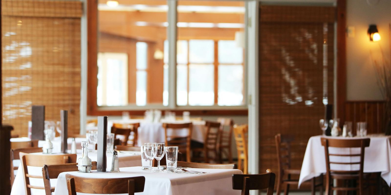 A spacious dining area with wooden chairs and tables