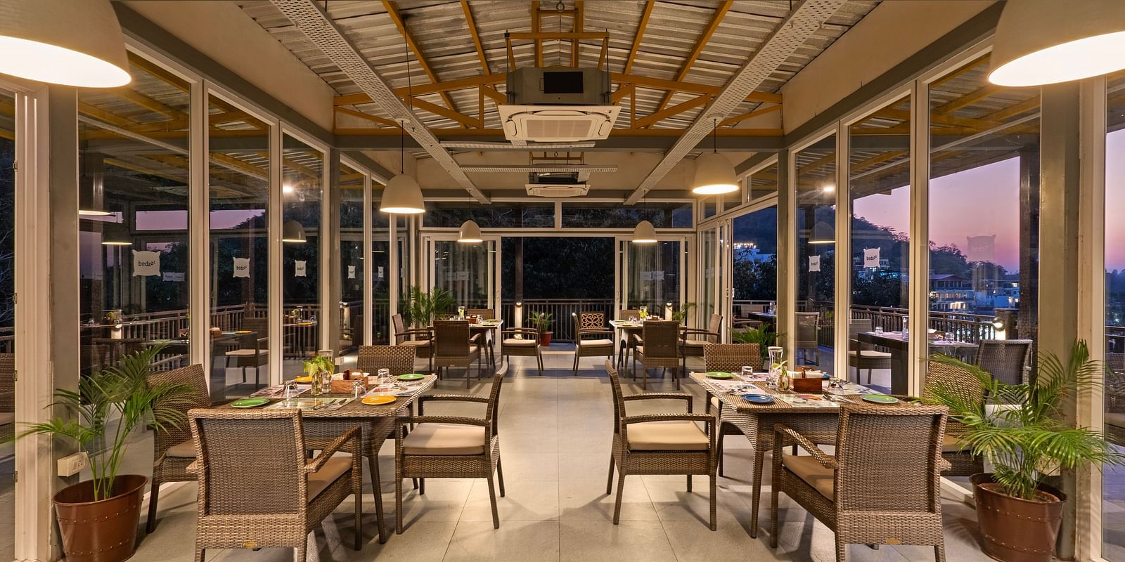 Dining area with air conditioner, featuring elegant decor and ambient lighting at Bedzzz, Rishikesh