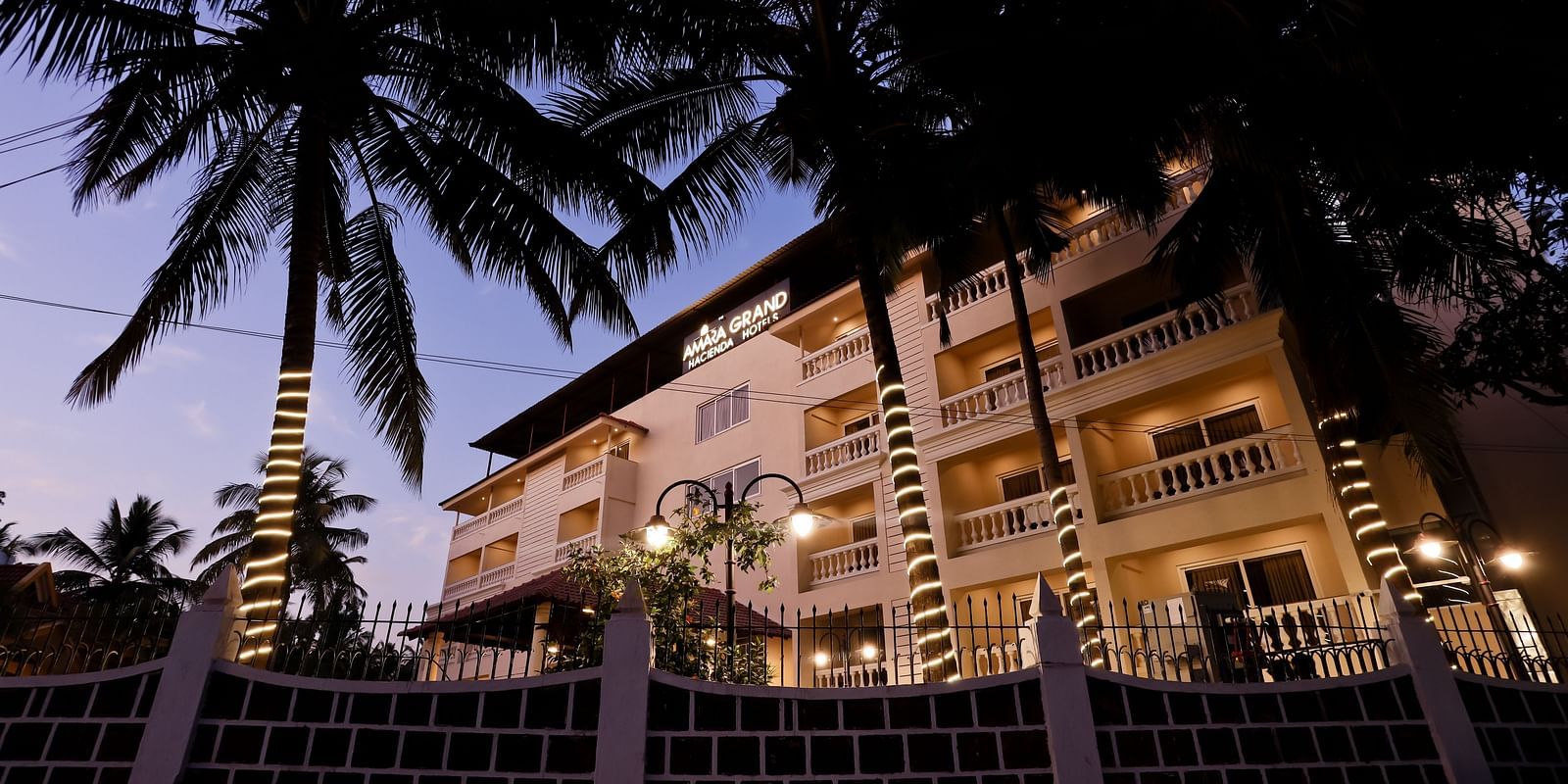 Facade of Calux Grand Baga with trees on the side.