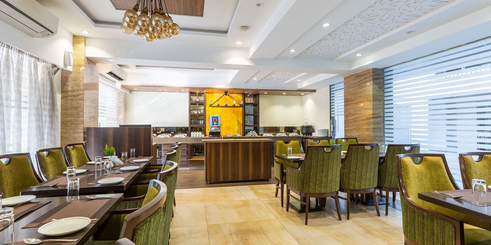 Image of a dining area with tables and chairs at Calux Grand Inn, Calangute.