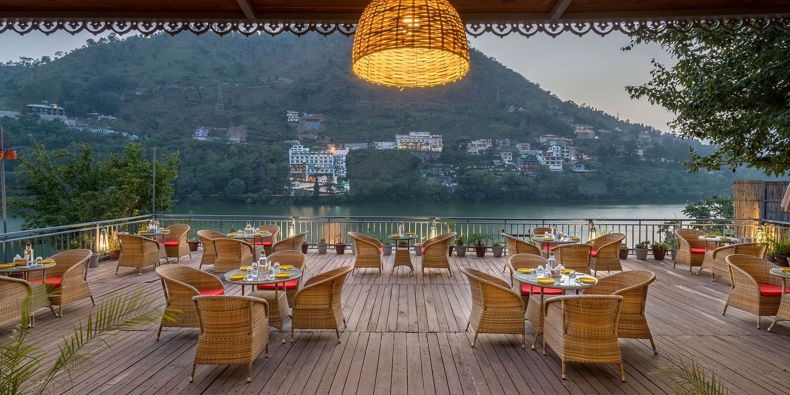 Wide angle shot of L-attitude deck with a beautiful lake and mountain view at Fishermen's Lodge, Bhimtal 
