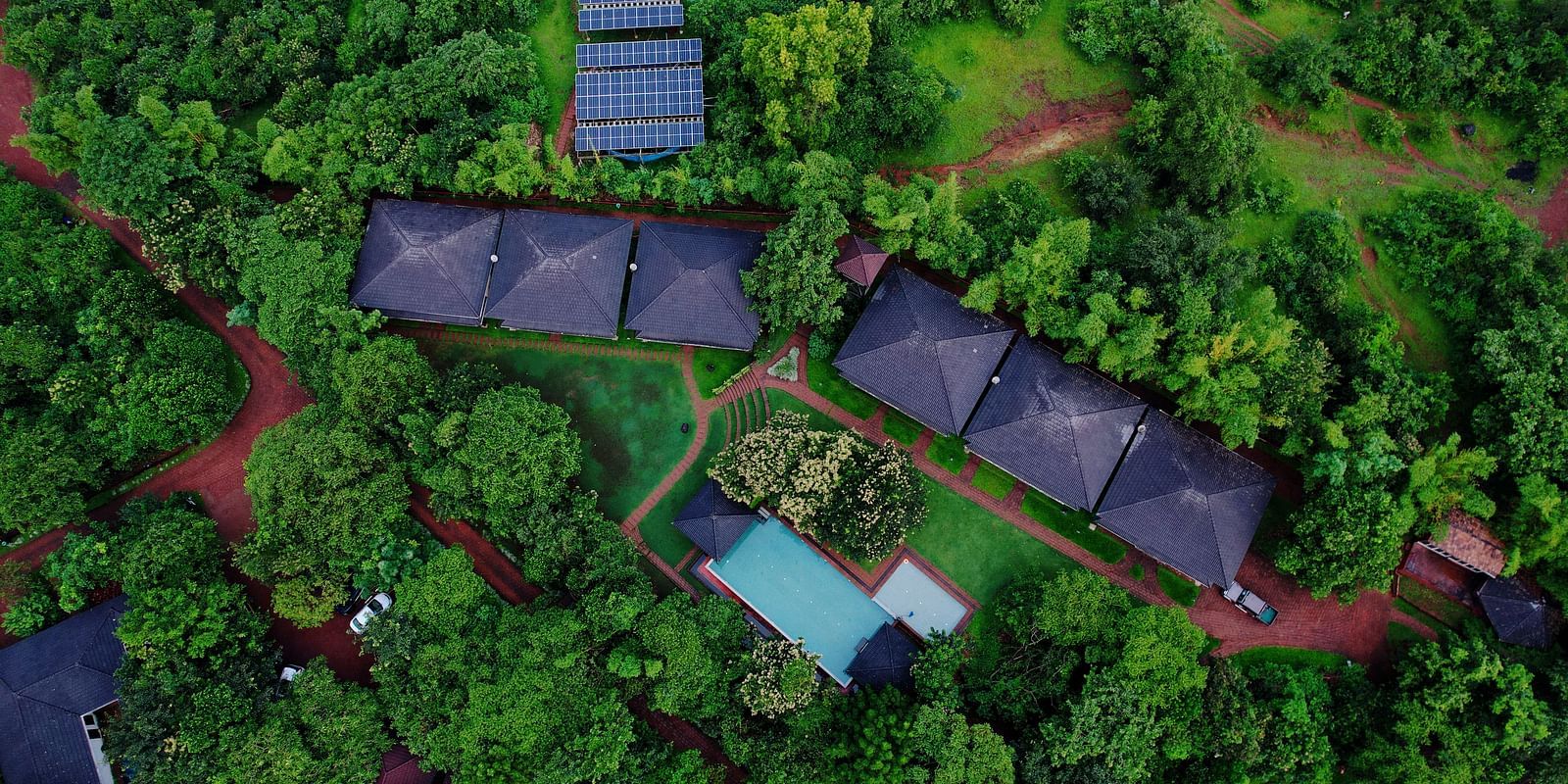 This aerial view of Forest Escape presents several cabins and a smaller pool area integrated into the natural forest.