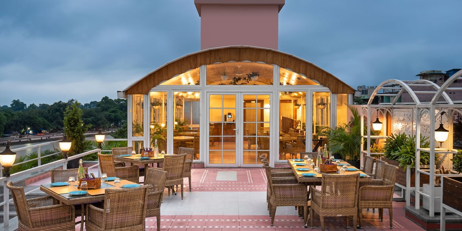 Restaurant Patio with the outdoor dining arrangement with tables and chairs  in clusters - Ganga Lahari, Haridwar