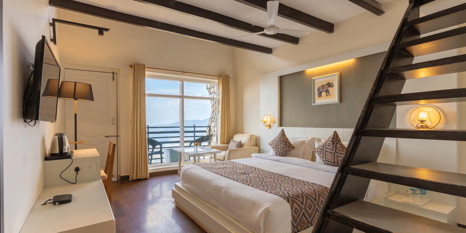 A modern guest suite featuring a white bed and a wooden staircase leading to a mezzanine level at Himalayas Resort By The Lake Hill, Mukteshwar.