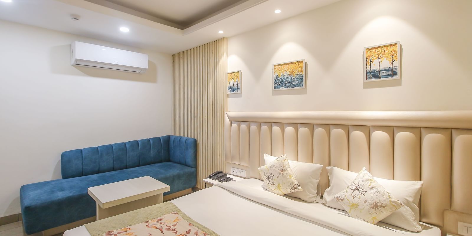 Twin bedded room with seating area at Hotel Diamond Plaza, Chandigarh