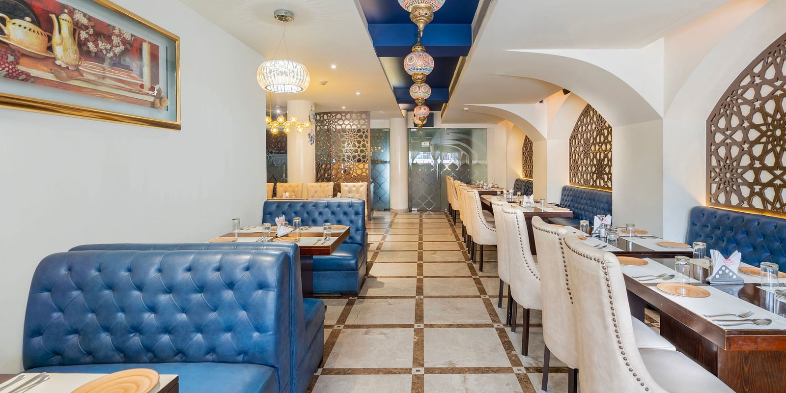 A n aisl view of the restaurant along with comfy sofa and table  Hotel Moti palace .