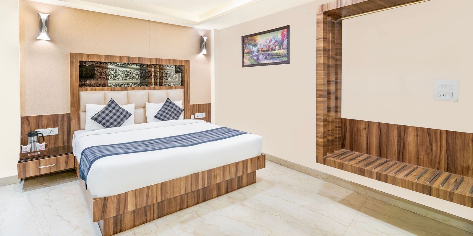 A corner view of the room at Hotel Moti Palace, focusing on the comfy bed.