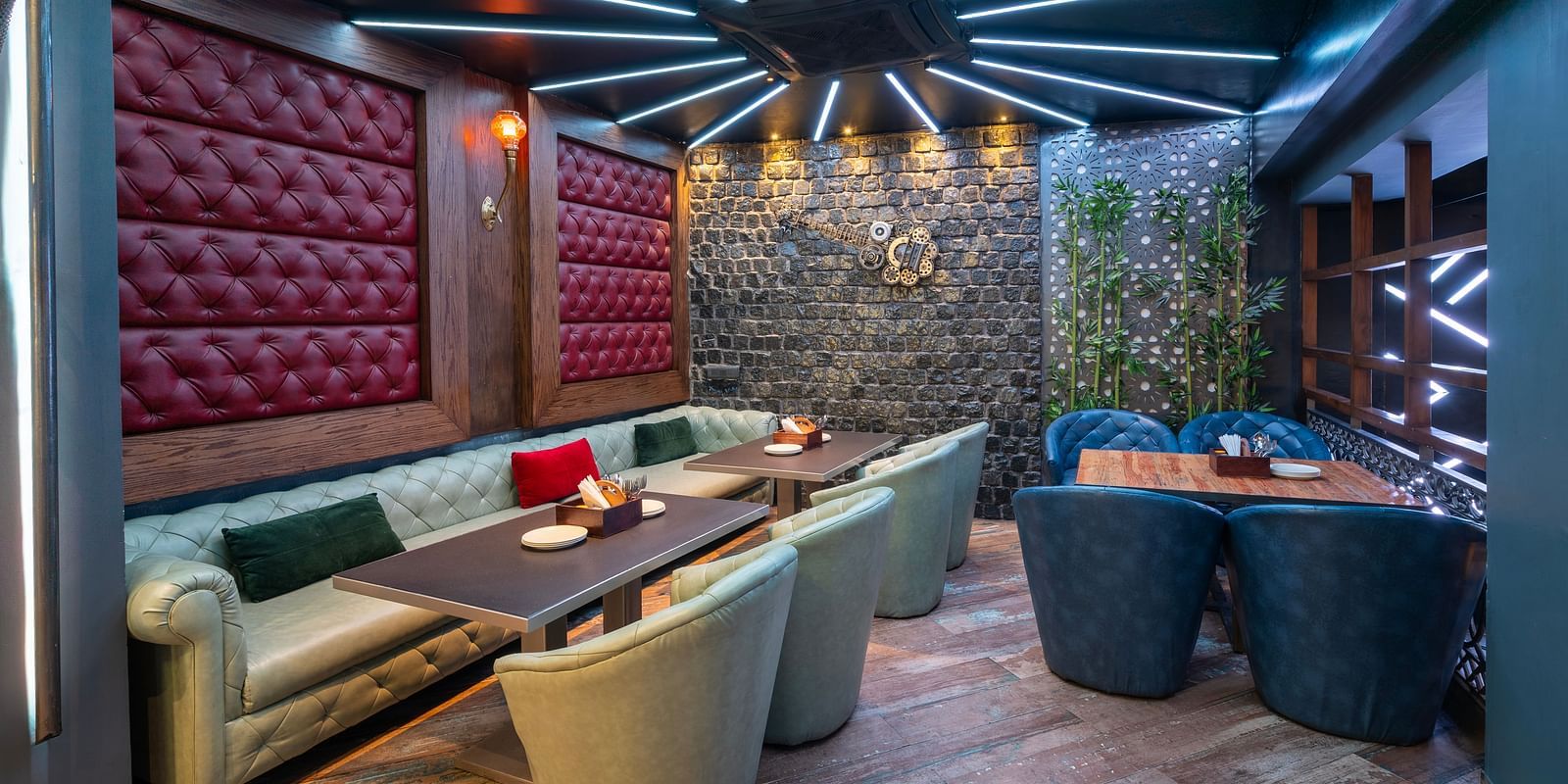 Interior view of the restaurant at Hotel Moti Palace, featuring comfy sofas and warm, ambient lighting