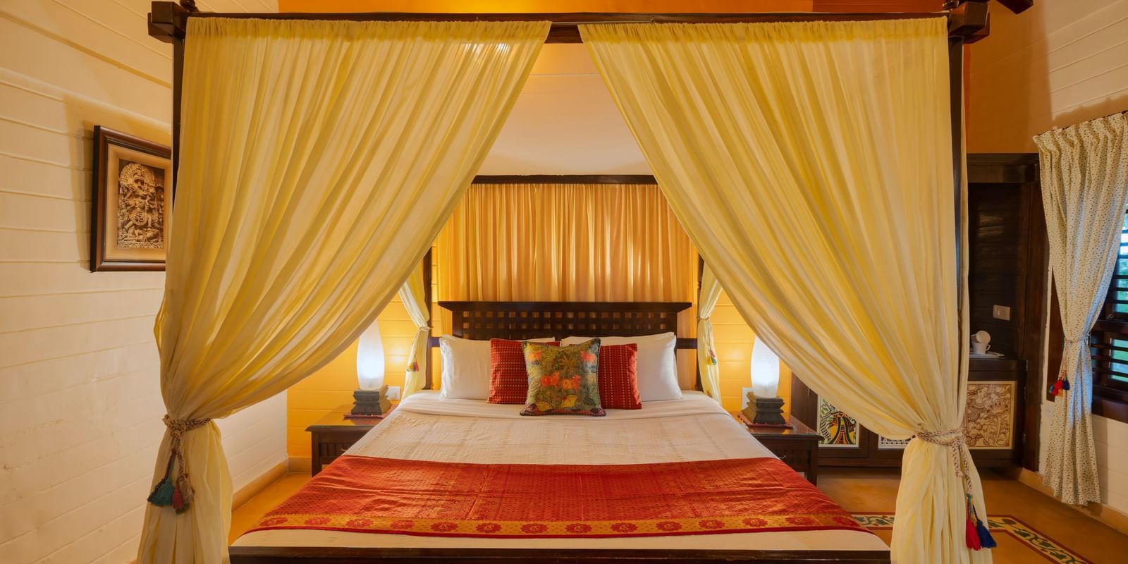 image of a comfortable king size bed at the heritage superior cottage at hoysala village resort in hassan