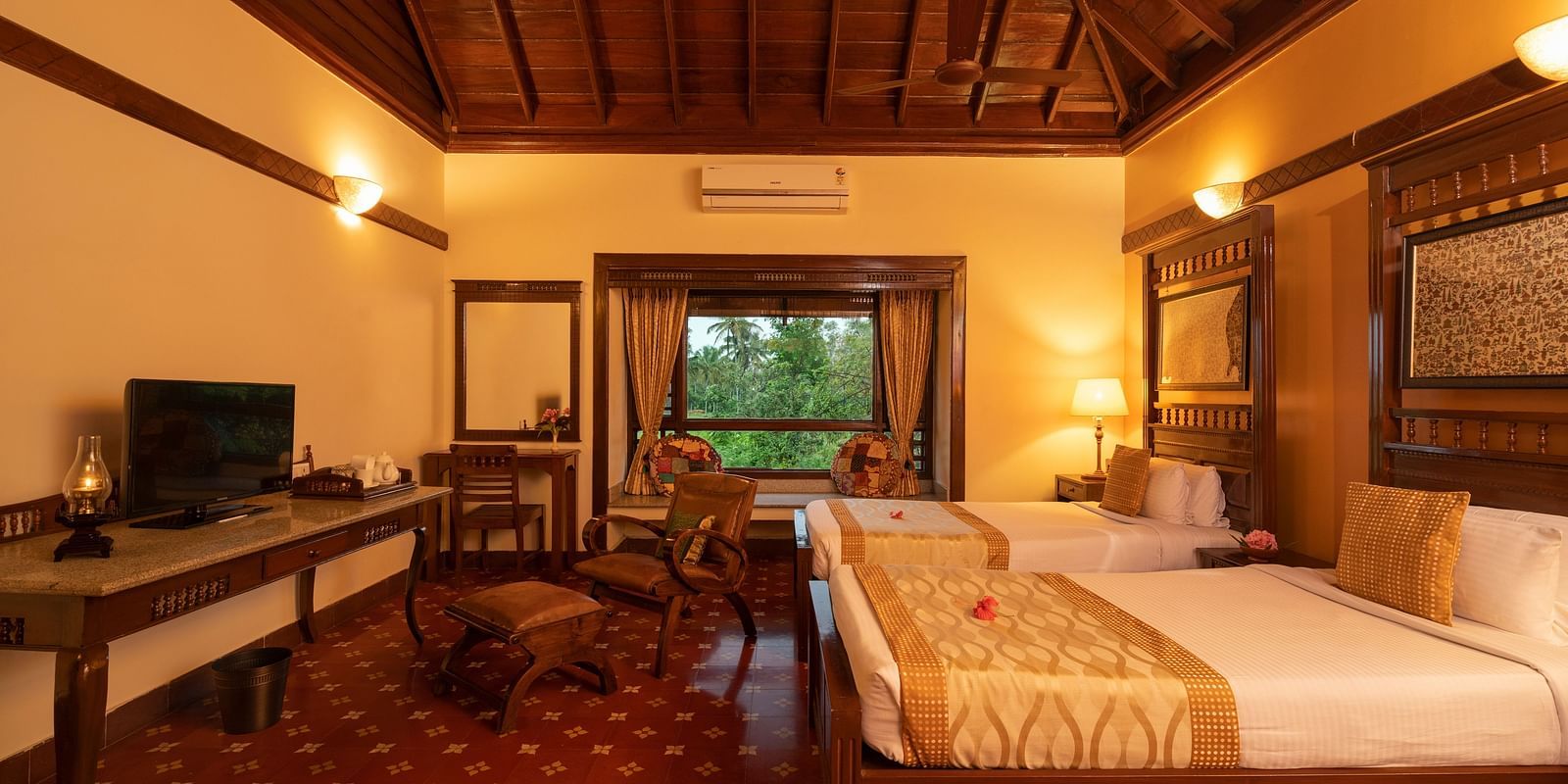 image of a twin bedroom of the heritage premium cottage featuring a brightly lit room at hoysala village resort