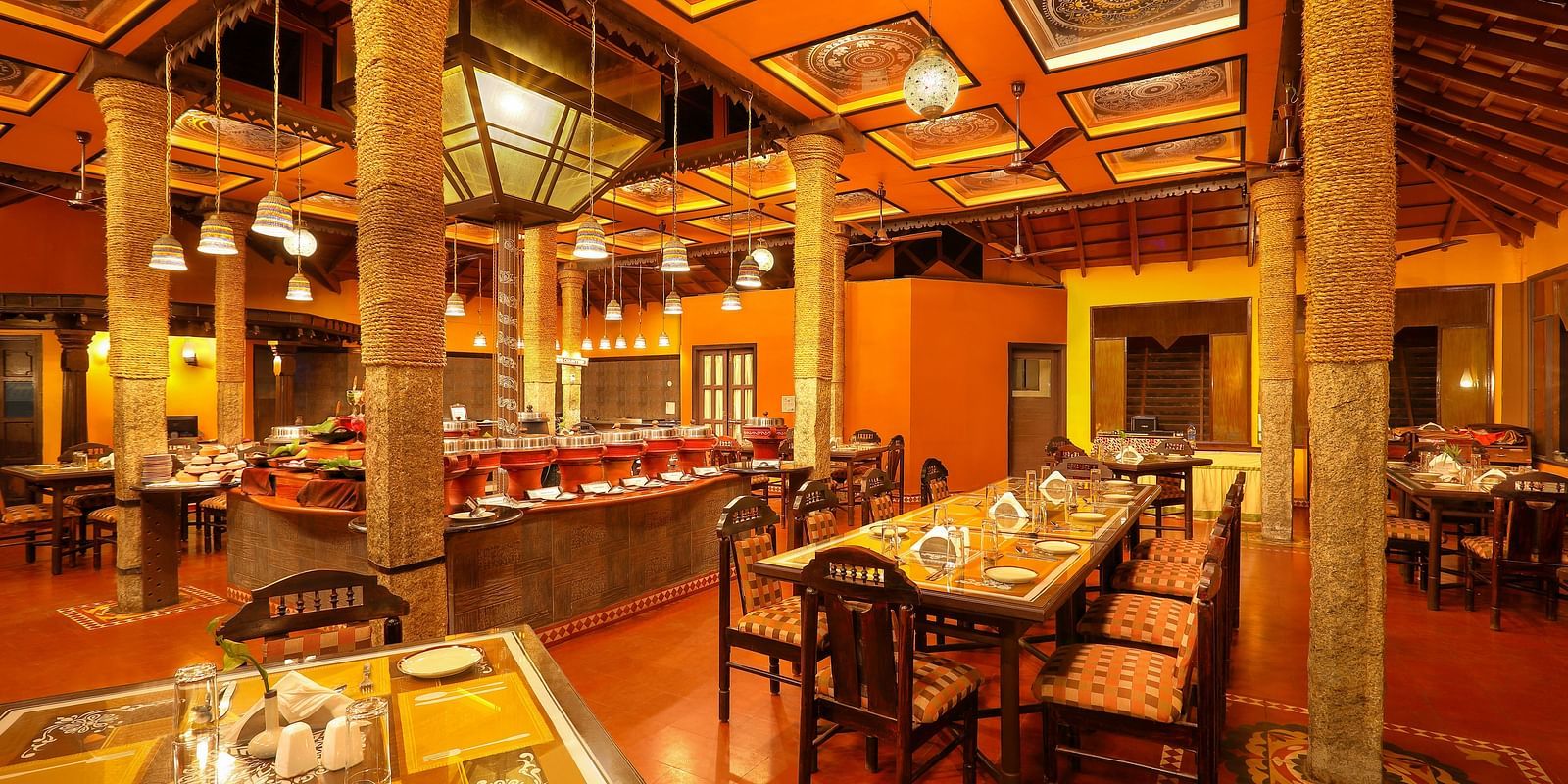 brightly lit Kokam Restaurant at Hoysala Village Resort, Hassan