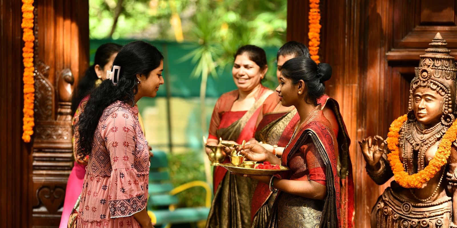 staff welcoming the guests at hoysala village resort, hassan