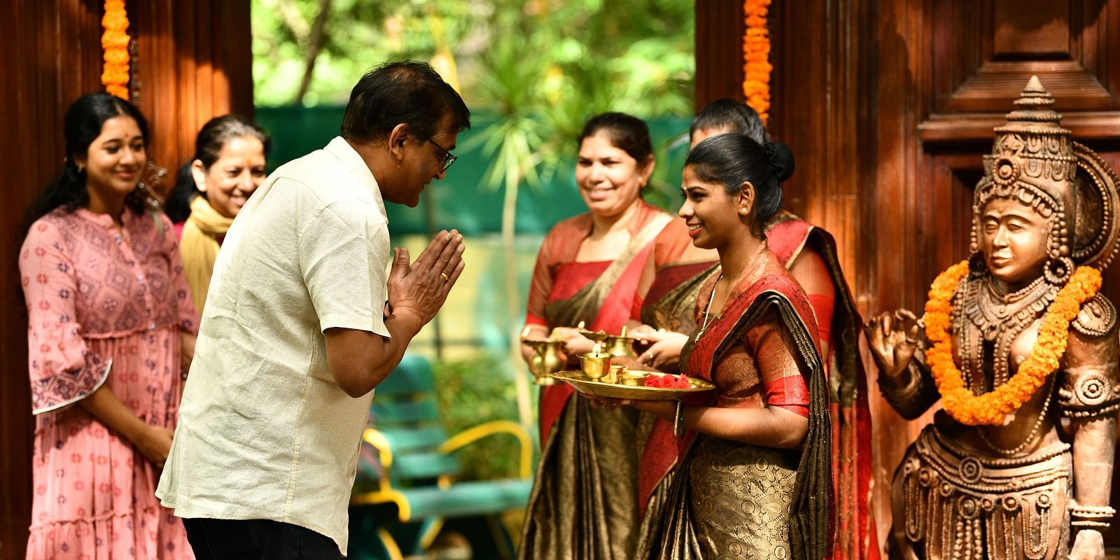 staff welcoming guests with tilak at Hoysala Village Resort, Hassan