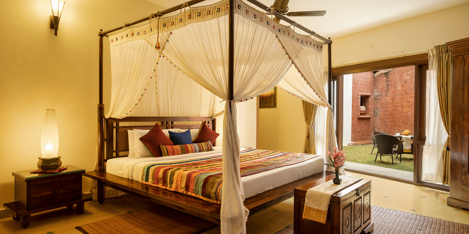 image of a bedroom featuring a lawn outside the luxury jacuzzi villa at hoysala village resort in hassan