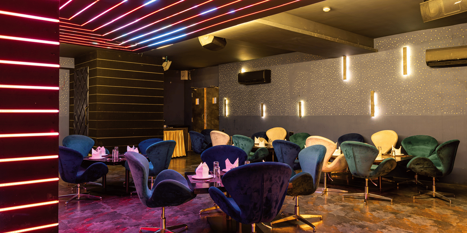 Contemporary indoor dining lounge of Re-Pub-Liq at Papaya Tree Hotels with artistic ceiling lighting and comfortable seating arranged for guests.