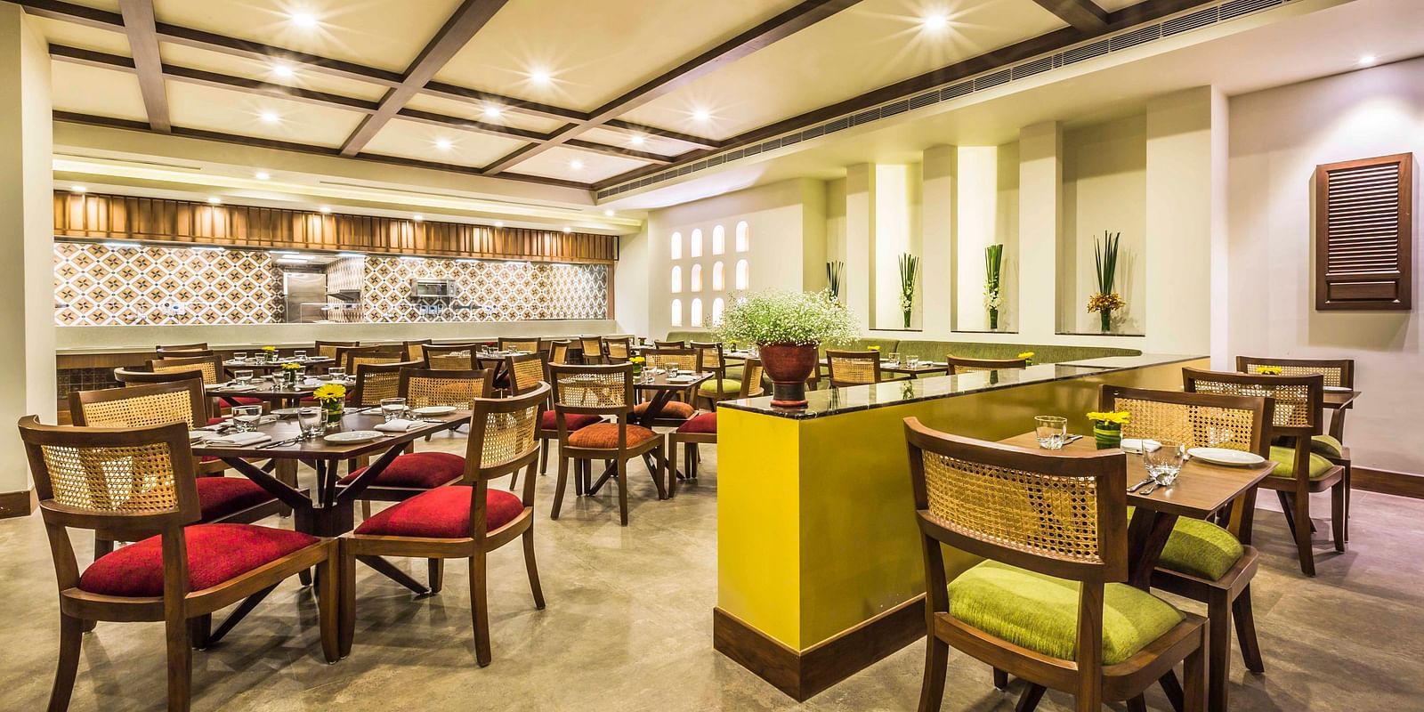 The cafe features cosy interiors with colourful chairs - Rhythm Lonavala