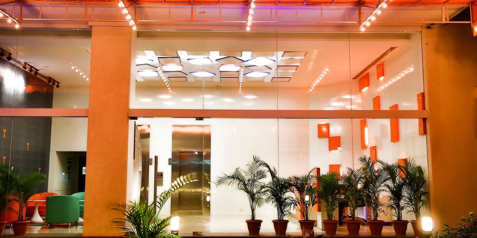 Entrance to T24 Residency, Andheri East, Mumbai with potted plants placed outside the glass doors