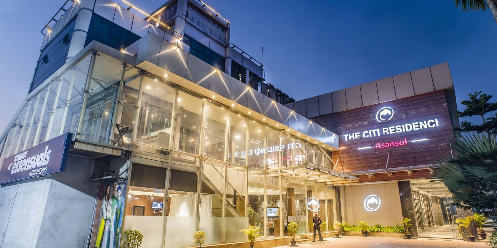 The exterior of The Citi Residenci Hotel, Asansol, at dusk with lights on.