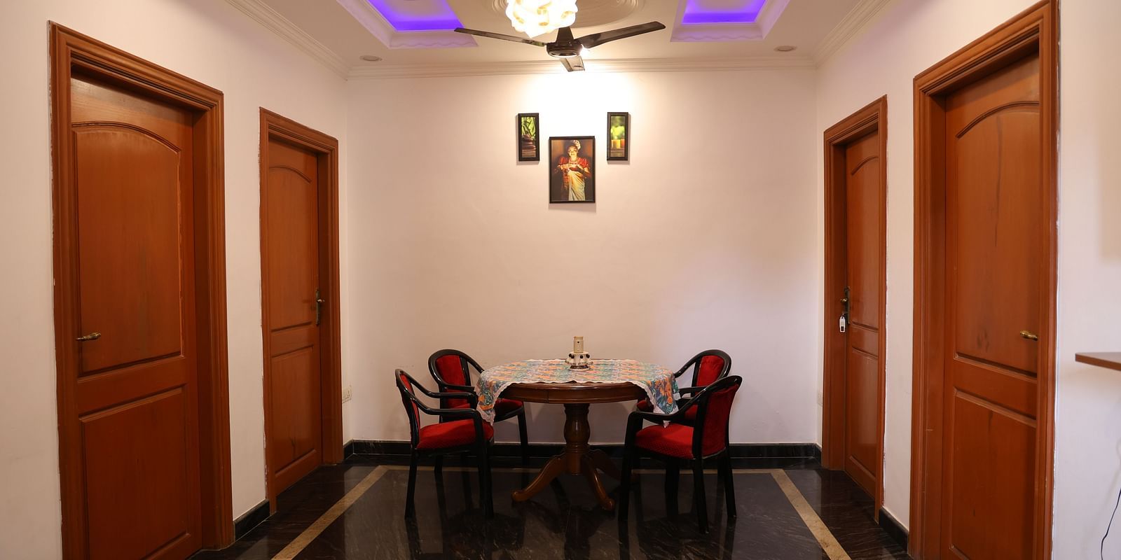 Image of a living room with a table and chairs around it at Villa Serenity Le Sejour, Pondicherry.