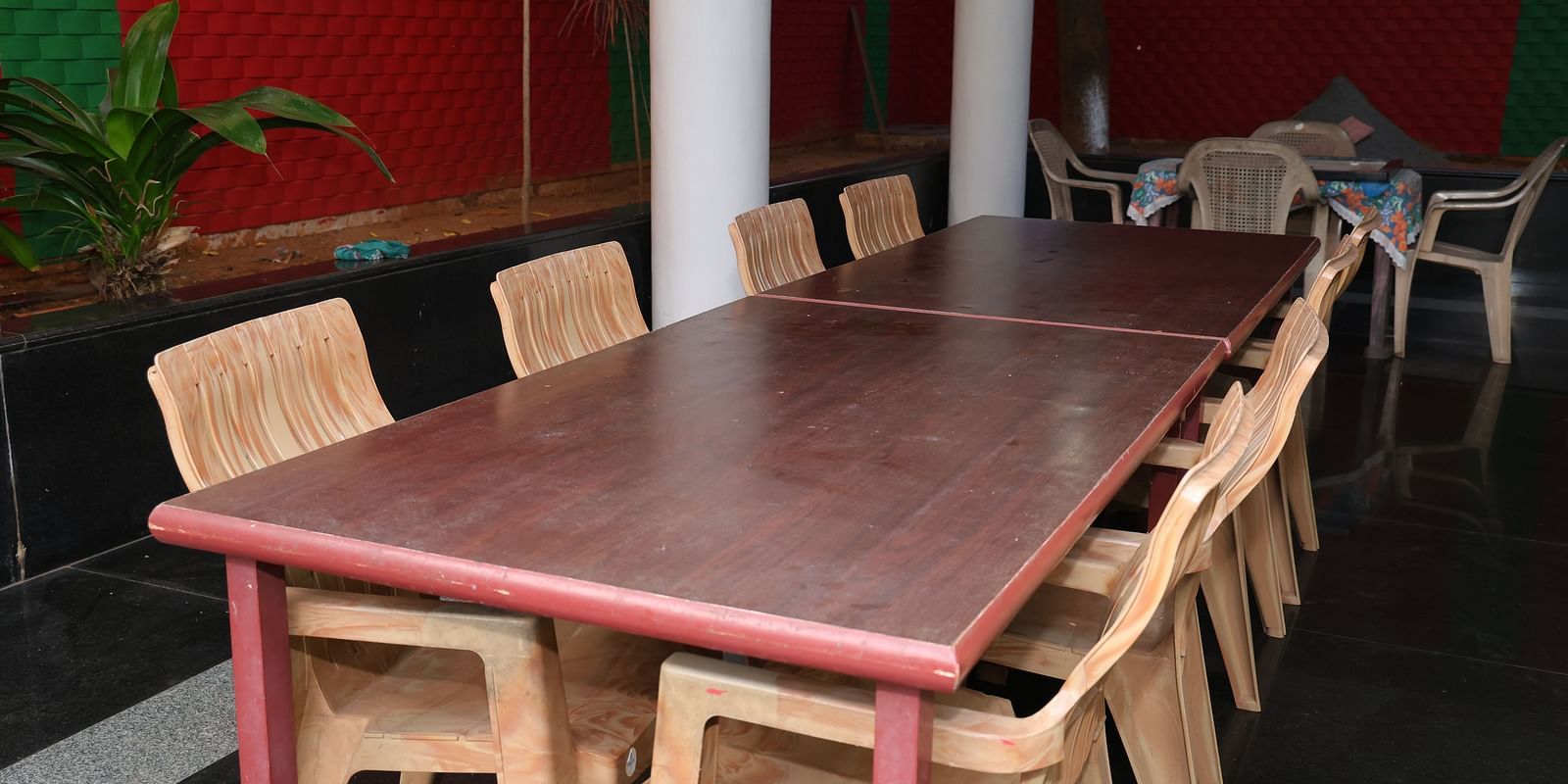 Image of a dining area with a rectangular table and chairs around it at Villa Serenity Le Sejour, Pondicherry.