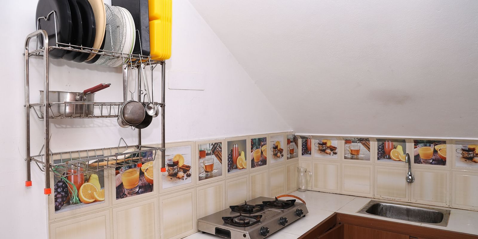 Image of a kitchen equipped with a stove and cutleries at Villa Serenity Le Sejour, Pondicherry.