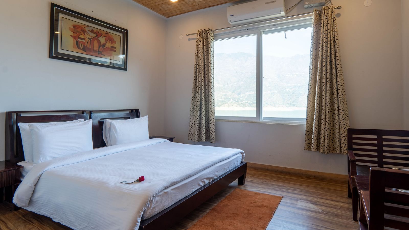 floating huts - over the lake bedroom with a posh bed placed next to the window with lake view - Le ROI Floating Huts Eco Rooms