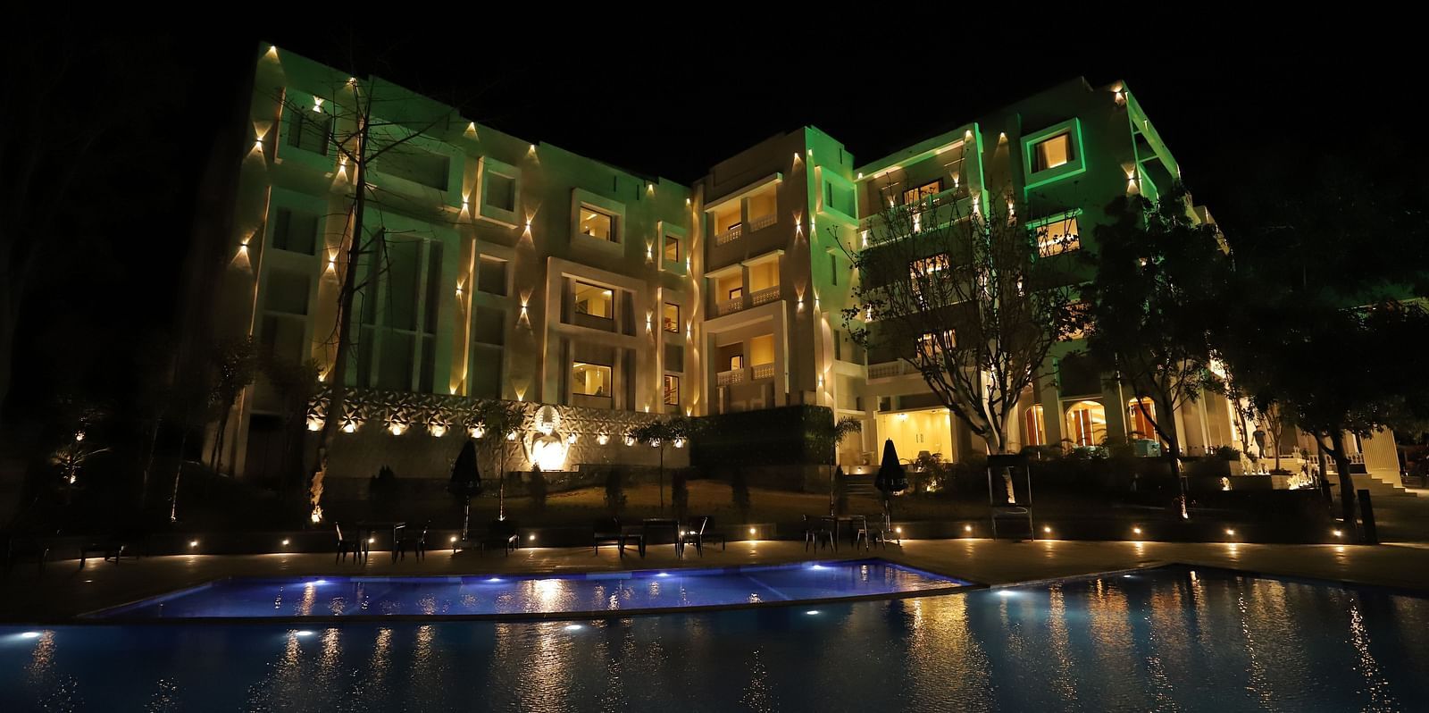 Night exterior view of Essentia Luxury Resort & Spa, Udaipur with the lights on 