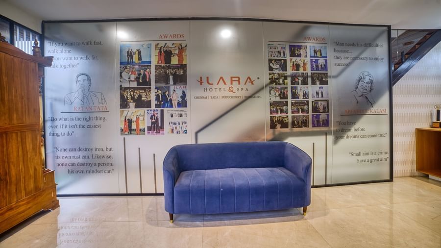 The spacious and well-lit hotel lobby featuring comfortable blue sofas, showcasing the contemporary interior design at Ilara Hotels & Spa, OMR, Chennai.