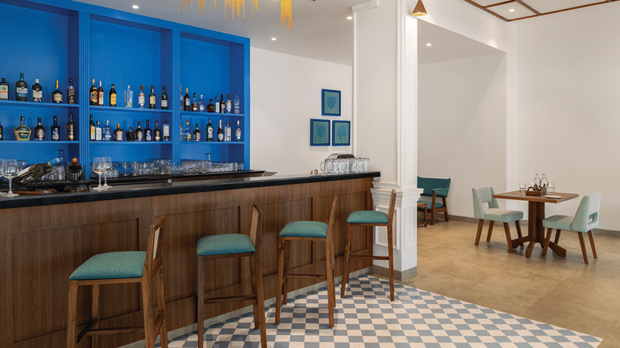 Indoor bar and dining area with seating and a tiled floor.