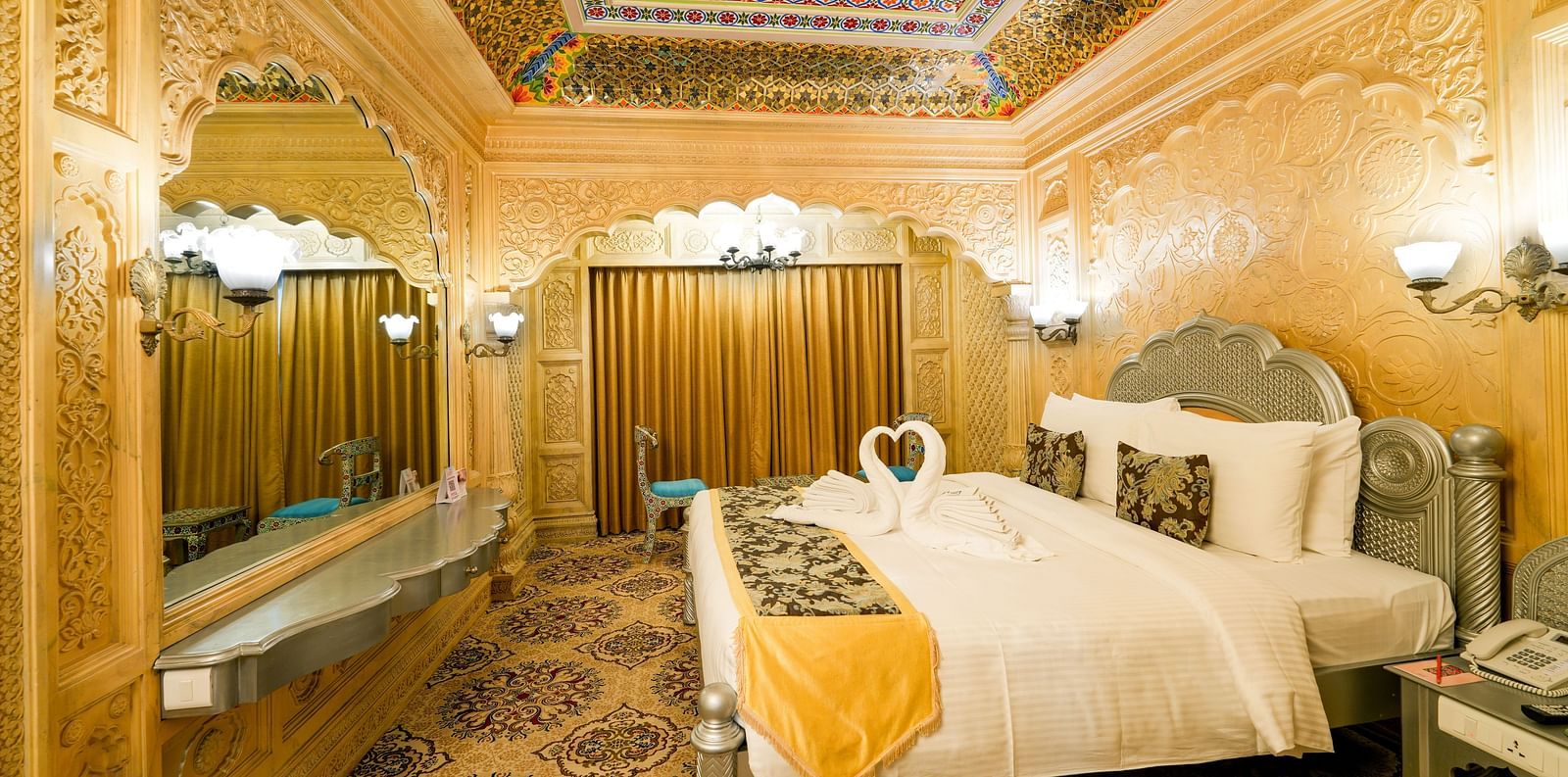 Themed room at Sitara Luxury Hotel in Hyderabad near Ramoji Film City with a king size bed and side tables