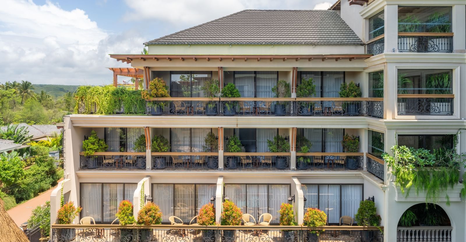 A bright facade of The Evren, Vagator, featuring the corridors decorated with plants.