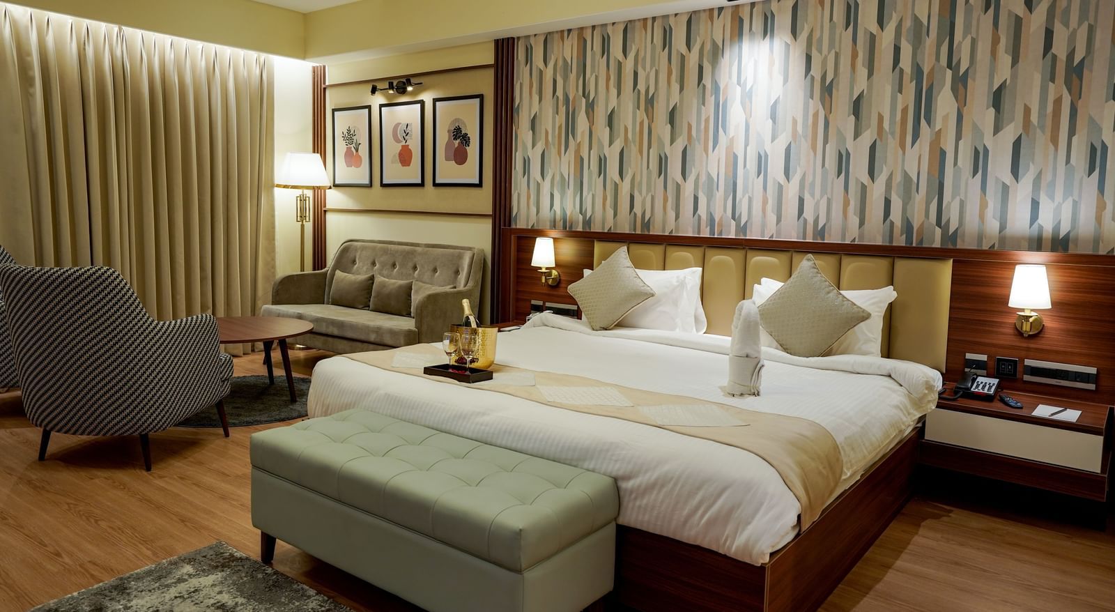 Corner view of the double bed in the Premium Room along with a common seating area in the corner of the room at M2 Square by Monday Premium.
