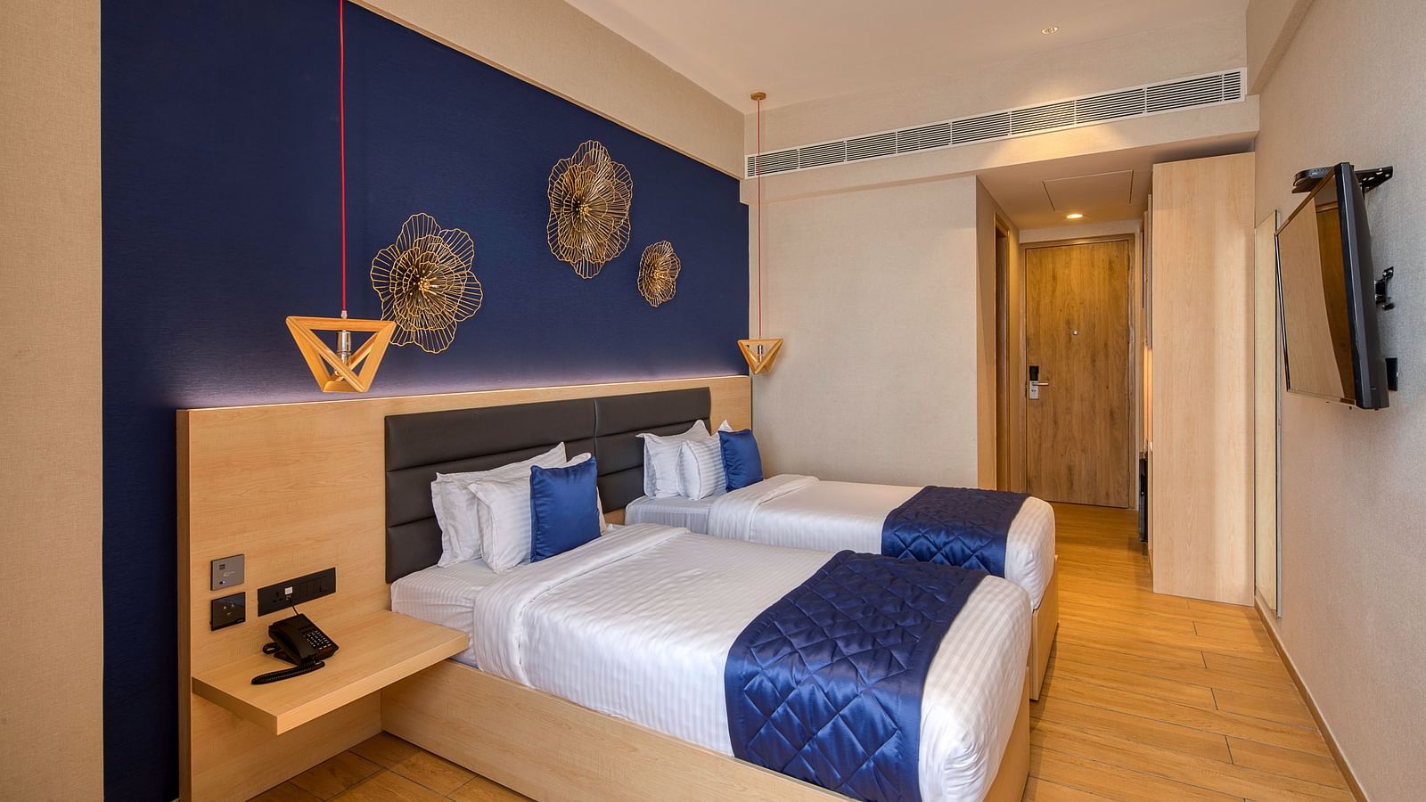 Twin beds with blue bedsheets and pillow covers at Executive Room at Le Foliage by TGI, Bangalore 2
