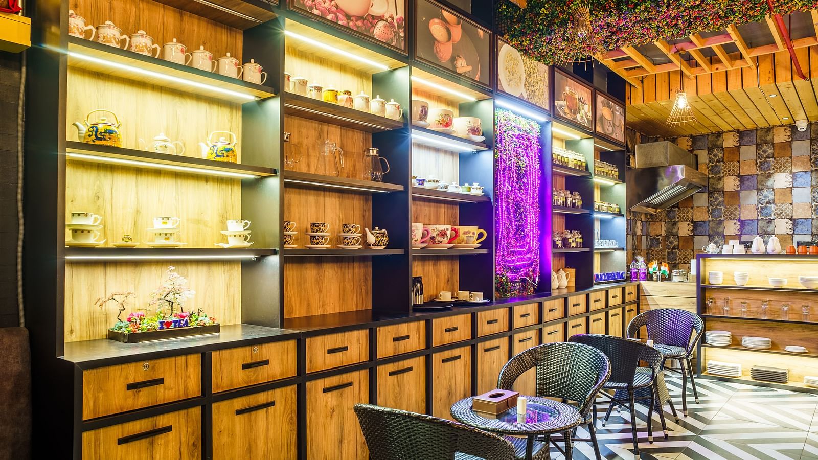 A wide shot of a restaurant at Orsino Spa Resort with walls lined with shelves filled with various items and bottles.