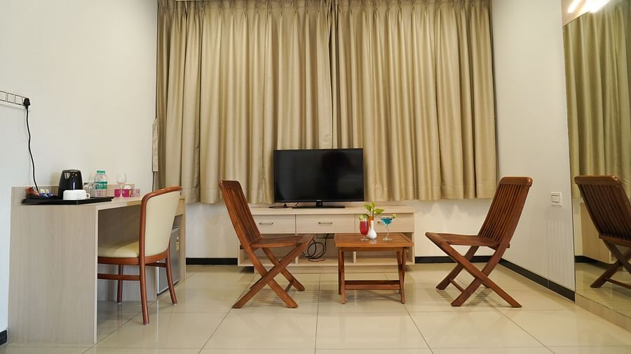 Pride Ranakpur Resort Convention Centre - interior view of the suite featuring a television a coffee table and work desk containing kettle and other items required to make a beverage