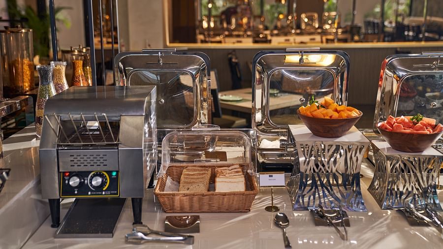 breads and cut fruits in a buffet station at Mishri, the restaurant at Triptam Hotel, Vrindavan