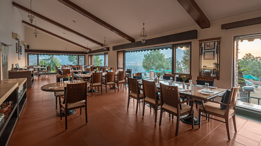 Restaurant area fully wooden furnished with a beautiful view at Baikuth resort, kasauli.