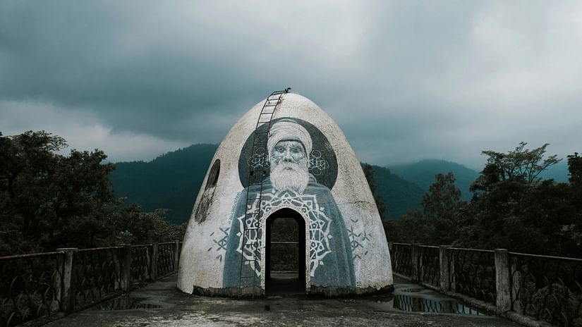 Traditional domed meditation cave against misty sky in mountainous valley