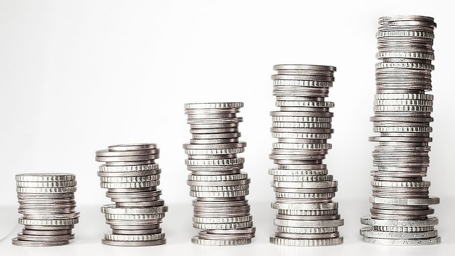 A close up of coins stacked on top of each other in a pile of five.