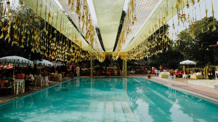 Poolside wedding setup with floral hangings and elegant decor at Umaid Palace -Luxury Destination Wedding Resort in Jaipur 