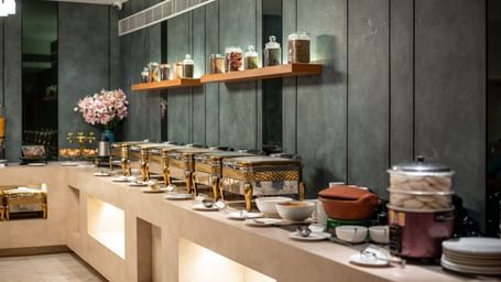 Buffet spread with assorted jars and traditional pots at Hotel Royal Regency Chennai