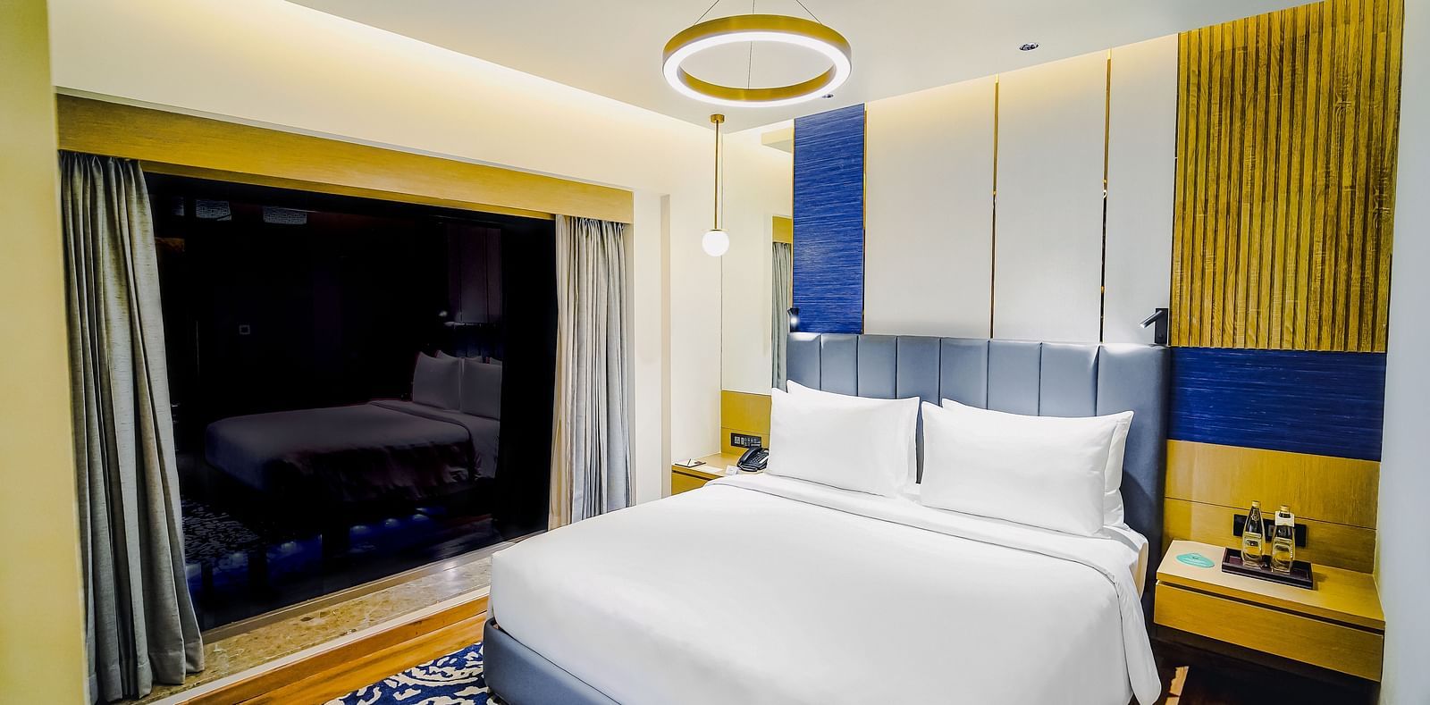 An image of a suite in Madurai with a plush bed and ambient lighting - Grand Madurai by GRT Hotels