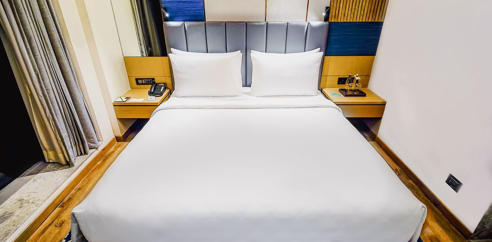 A close up shot of a bed in our Junior Suite in Madurai with plush pillows - Grand Madurai by GRT Hotels 
