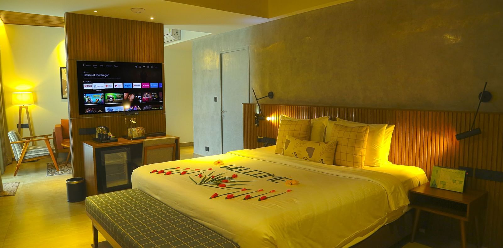 An image of the pent house with a king size bed, couch, bed side table, flat screen TV, and separate living area - Great Trails Yercaud by GRT Hotels - Yercaud Family Rooms