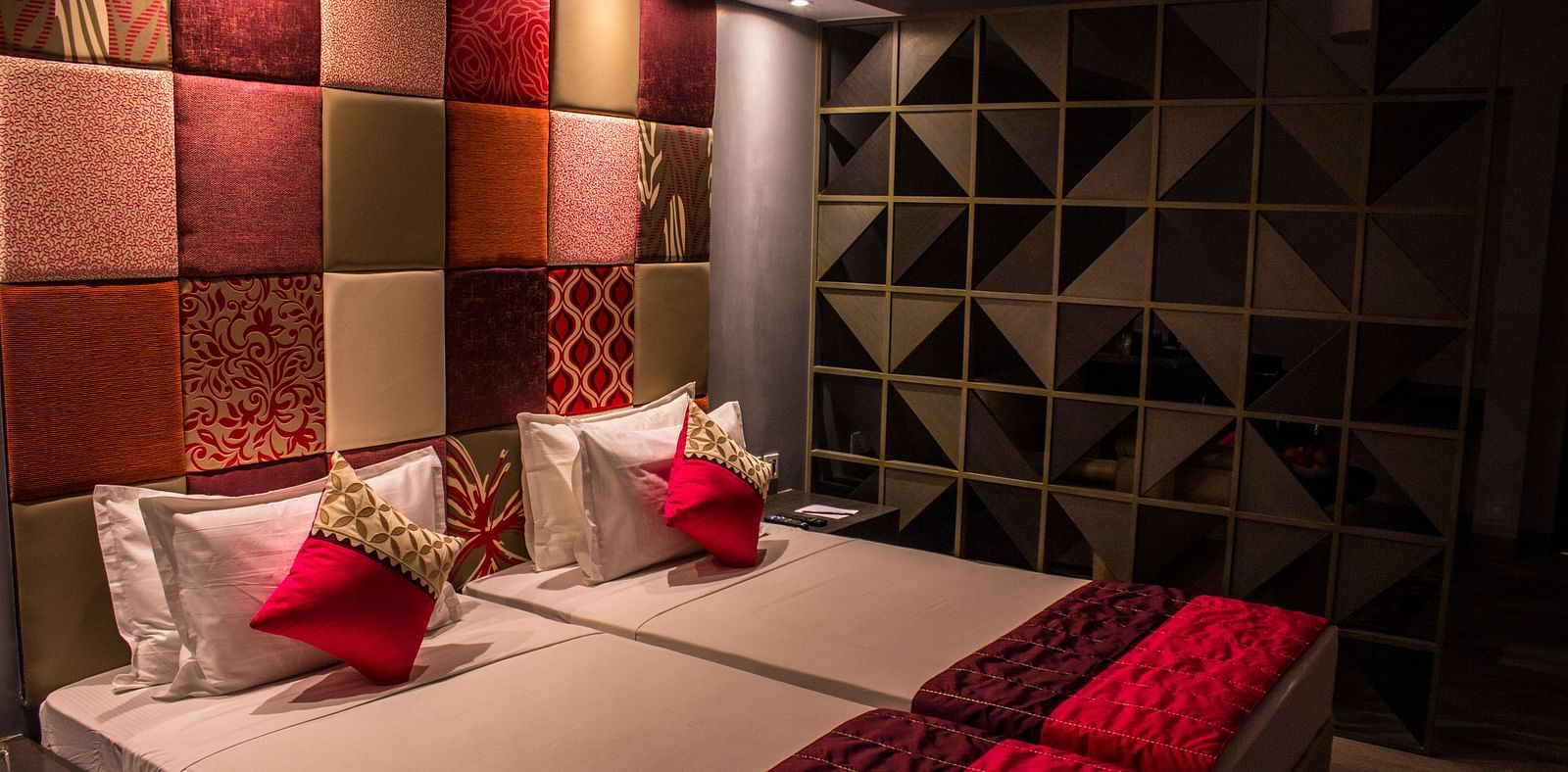 A room with twin beds and  pillows arranged on it  | Regency Tirunelveli By GRT Hotels