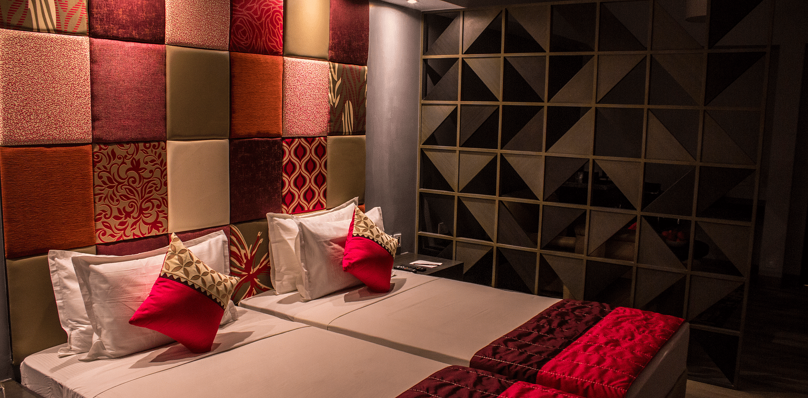 A room with twin beds and  pillows arranged on it  | Regency Tirunelveli By GRT Hotels