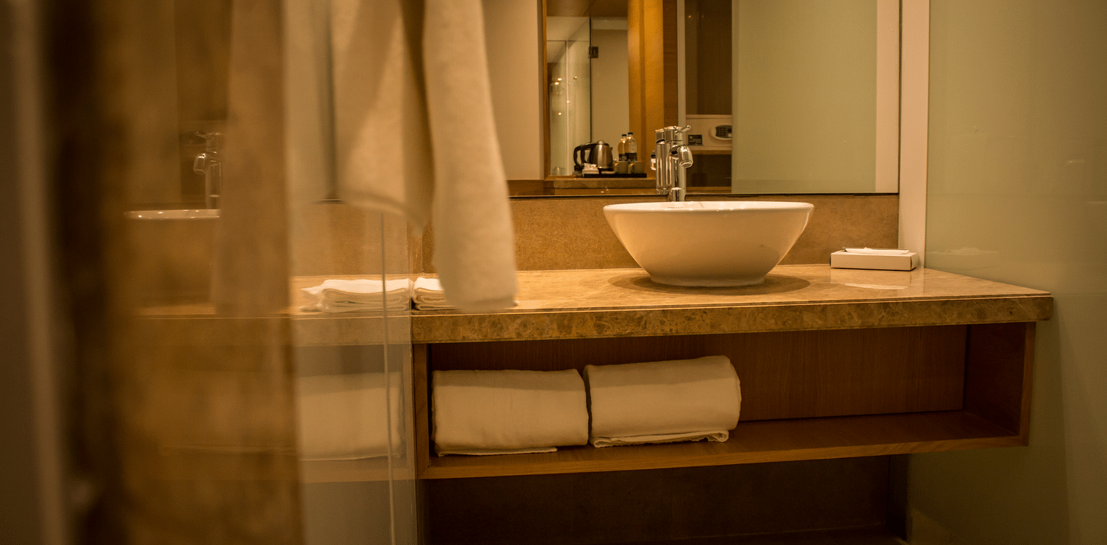 Image of an bathroom with a sink, mirrors  and towels | Regency Tirunelveli By GRT Hotels