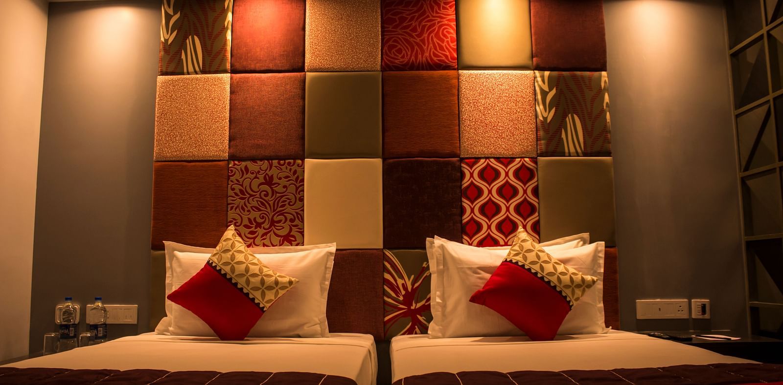 A room with twin beds and  pillows arranged on it  | Regency Tirunelveli By GRT Hotels