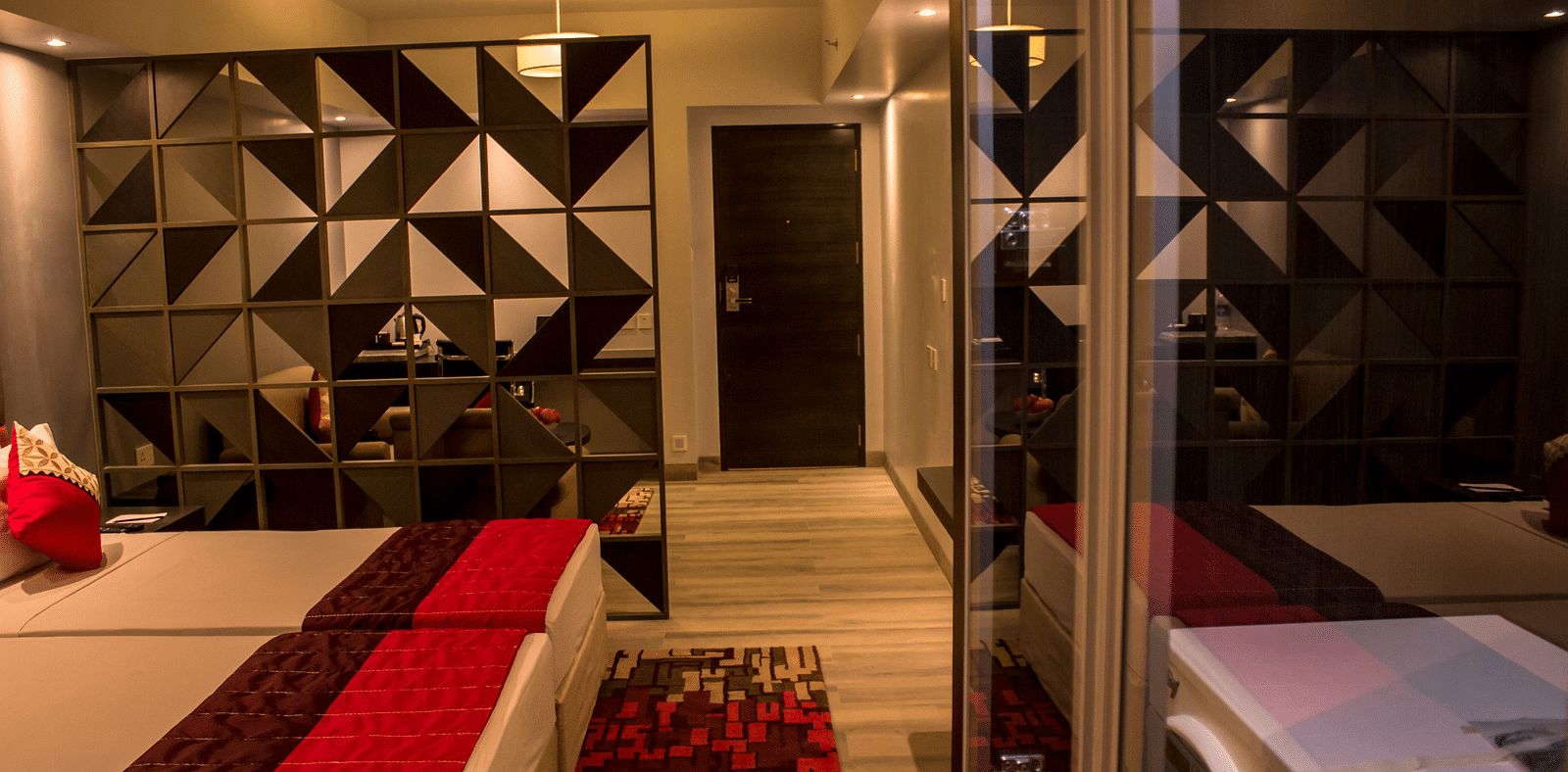 Side view of a room with twin beds and  pillows arranged on it  | Regency Tirunelveli By GRT Hotels